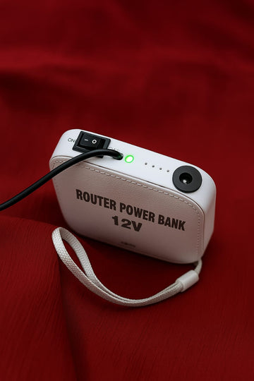 Blue slim-box mini UPS for WiFi router, front view — compact unit with 12V output for internet backup during load-shedding
