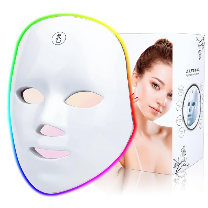 Close-up of the white 7-colour LED photon face mask with multicolour glow, shown with its gift box