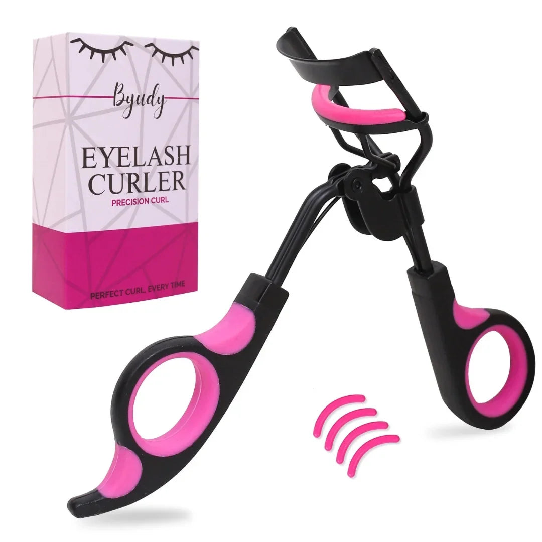 Professional eyelash curler — angled product shot of the black and pink mechanical curler with retail box and silicone replacement pads