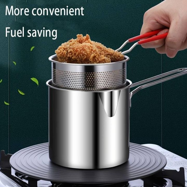 Lifting fried chicken from the fryer pot — red-tipped handles stay cool while cooking