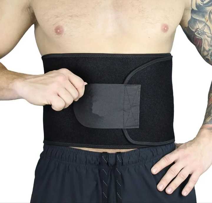Man fastening black neoprene hot waist trimmer belt with wide velcro strap